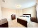 Well-lit bedroom with soft carpet and a large bed and matching wood furniture at 9207 Busaco Park Way, Winter Garden, FL 34787