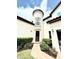Close up of the home's front entrance and yard, with cylindrical tower on the left at 9207 Busaco Park Way, Winter Garden, FL 34787