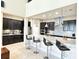 Modern kitchen with dark cabinetry, stainless steel appliances, and a large island with bar seating at 9207 Busaco Park Way, Winter Garden, FL 34787