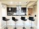 Bright kitchen with a spacious speckled island, modern pendant lights, tile backsplash, and stainless steel appliances at 9207 Busaco Park Way, Winter Garden, FL 34787