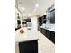 Spacious kitchen with dark cabinets, granite counters, stainless appliances, and an oversized island with seating at 9207 Busaco Park Way, Winter Garden, FL 34787