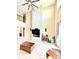 Open-concept living room with high ceilings, a stone fireplace, and lots of natural light at 9207 Busaco Park Way, Winter Garden, FL 34787