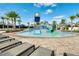 Community pool area features a splash pad for , surrounded by lounge chairs and palm trees at 9207 Busaco Park Way, Winter Garden, FL 34787