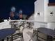 Rooftop deck with outdoor seating and a stunning view of a fireworks display at 9207 Busaco Park Way, Winter Garden, FL 34787
