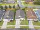 Aerial view of houses with well-manicured lawns and driveways in a residential area at 958 High Point Loop, Longwood, FL 32750
