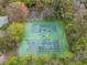 Aerial view of community tennis and basketball courts, bordered by mature trees at 958 High Point Loop, Longwood, FL 32750