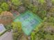 Aerial view of community tennis and basketball courts, surrounded by lush trees at 958 High Point Loop, Longwood, FL 32750