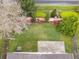 Aerial view of the home's backyard, showcasing a well-maintained lawn, patio and colorful landscaped garden at 958 High Point Loop, Longwood, FL 32750