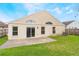 A cozy backyard with a concrete patio, lush green grass and a well-maintained lawn at 958 High Point Loop, Longwood, FL 32750