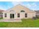 A cozy backyard with a concrete patio, lush green grass and a well-maintained lawn at 958 High Point Loop, Longwood, FL 32750