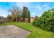Expansive backyard featuring lush greenery, defined landscaping, and a concrete patio perfect for outdoor enjoyment at 958 High Point Loop, Longwood, FL 32750