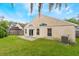 A cozy backyard with a concrete patio, lush green grass and a well-maintained lawn at 958 High Point Loop, Longwood, FL 32750