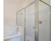 Modern bathroom with glass enclosed shower and a soaking tub at 958 High Point Loop, Longwood, FL 32750