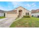 Inviting one-story home featuring an attached garage, manicured lawn, and attractive curb appeal at 958 High Point Loop, Longwood, FL 32750