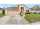 Charming one-story home with a two-car garage, arched entryway, and well-kept lawn at 958 High Point Loop, Longwood, FL 32750