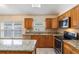 Well-equipped kitchen with granite countertops, stainless steel appliances, and wooden cabinetry at 958 High Point Loop, Longwood, FL 32750