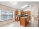 Bright kitchen features granite counters, stainless appliances, skylight, and central island at 958 High Point Loop, Longwood, FL 32750