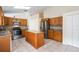 Bright kitchen features granite counters, stainless appliances, tile floors and wood cabinets at 958 High Point Loop, Longwood, FL 32750
