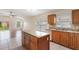 Stylish kitchen featuring granite counters, stainless steel appliances, island, and ample cabinet space at 958 High Point Loop, Longwood, FL 32750