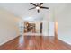 Open-concept living room with hardwood floors adjacent to kitchen and featuring ample natural light at 958 High Point Loop, Longwood, FL 32750