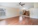 Open-concept living room with hardwood floors adjacent to kitchen and featuring ample natural light at 958 High Point Loop, Longwood, FL 32750