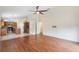 Open-concept living room with hardwood floors adjacent to kitchen and featuring ample natural light at 958 High Point Loop, Longwood, FL 32750