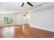 Bright living room with wood flooring, ceiling fan, and large window with natural light at 958 High Point Loop, Longwood, FL 32750