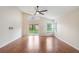 Spacious living room with hardwood floors, ceiling fan, sliding glass door, and vaulted ceiling at 958 High Point Loop, Longwood, FL 32750