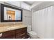 Bathroom features a modern vanity with granite countertops, toilet, and shower with curtain at 974 E Michigan St # 974, Orlando, FL 32806