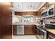 Modern kitchen featuring granite countertops and stainless steel appliances and dark wood cabinets at 974 E Michigan St # 974, Orlando, FL 32806