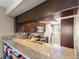 Updated kitchen with granite countertops, a breakfast bar, and wood cabinetry at 974 E Michigan St # 974, Orlando, FL 32806