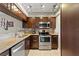 Modern kitchen with stainless steel appliances, granite countertops, and dark wood cabinets at 974 E Michigan St # 974, Orlando, FL 32806