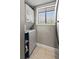 A laundry room with stacked washer and dryer with a window providing natural light at 974 E Michigan St # 974, Orlando, FL 32806