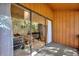 Outdoor patio with wood paneling, sliding glass doors, and views of nature at 974 E Michigan St # 974, Orlando, FL 32806