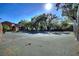 Community tennis court surrounded by green foliage and mature trees in a sunny outdoor setting at 974 E Michigan St # 974, Orlando, FL 32806