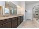 Bathroom with double sinks, granite countertops, tiled floors, and a separate shower at 985 Huntspoint St, Winter Garden, FL 34787