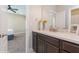 Bathroom features a marble vanity with dark brown cabinetry and modern fixtures at 985 Huntspoint St, Winter Garden, FL 34787