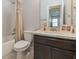 Bathroom features dark brown cabinetry, marble countertops, and a shower-tub combo at 985 Huntspoint St, Winter Garden, FL 34787