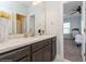 Bathroom with vanity, a framed mirror, and a view into the adjacent bedroom at 985 Huntspoint St, Winter Garden, FL 34787