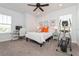 Bright bedroom featuring neutral colors, carpeted floor, ceiling fan, and an elliptical workout machine at 985 Huntspoint St, Winter Garden, FL 34787