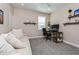 Bedroom features grey carpet, a couch and shelving, and a black desk chair at 985 Huntspoint St, Winter Garden, FL 34787