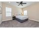 Cozy bedroom with grey carpet, a tufted headboard, and abundant natural light at 985 Huntspoint St, Winter Garden, FL 34787