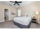 Cozy bedroom with grey carpet, tufted headboard, and natural light from two windows at 985 Huntspoint St, Winter Garden, FL 34787