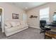 Bedroom features grey carpet, a large window, desk, and a comfortable couch at 985 Huntspoint St, Winter Garden, FL 34787