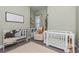 Comfortable Bedroom with a crib, comfortable chair, and plenty of natural light at 985 Huntspoint St, Winter Garden, FL 34787