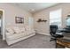 Bedroom featuring a couch, work desk, mounted shelving, and a window providing natural light at 985 Huntspoint St, Winter Garden, FL 34787