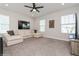 Bright bonus room with plush carpeting, ample lighting, and a comfortable sectional at 985 Huntspoint St, Winter Garden, FL 34787