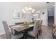 Dining room featuring a chandelier, wood floors, stairs and neutral tones at 985 Huntspoint St, Winter Garden, FL 34787