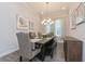 Dining room with a wooden table, chairs, bench, chandelier, and decorations with natural light from the window at 985 Huntspoint St, Winter Garden, FL 34787