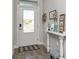 Bright foyer featuring stylish wood-look tile flooring and a decorative console table at 985 Huntspoint St, Winter Garden, FL 34787